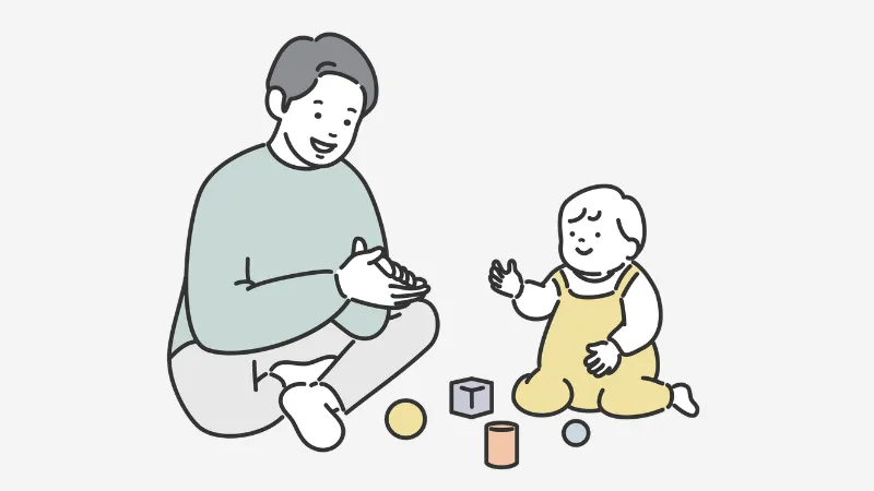 子どもと積み木遊びする男性