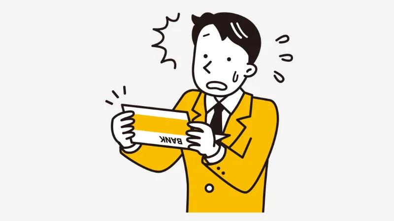 通帳を見て不安になる男性